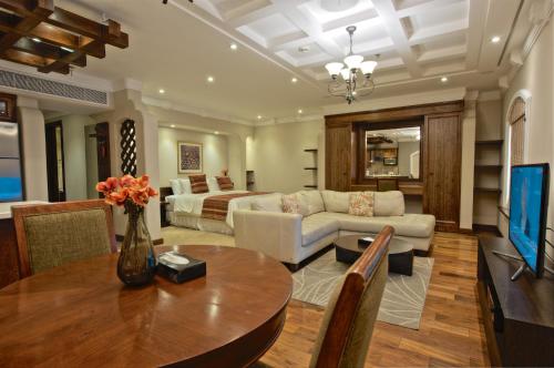 a living room with a couch and a table at Rawasi Hotel Apartments in Jeddah