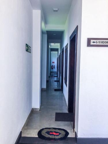 a hallway of a building with a rug on the floor at US Motel Colombo in Homagama