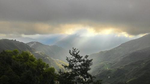 a view of a mountain valley with a rainbow in the sky at The fairy land - Lala Mountain in Fuxing