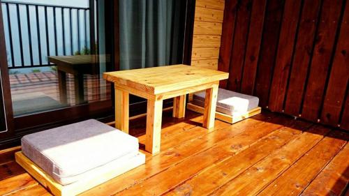 a wooden table sitting on top of a wooden floor at The fairy land - Lala Mountain in Fuxing