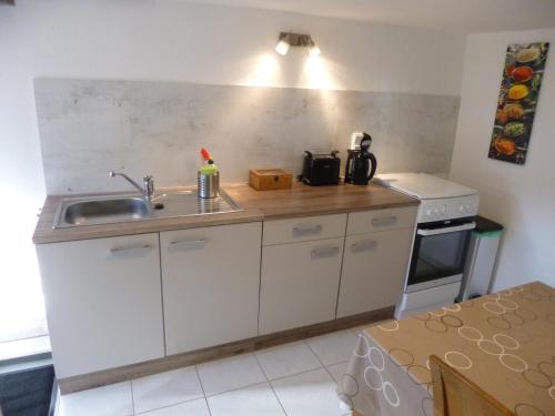 a small kitchen with a sink and a stove at Ferienwohnung Jansen "Eins" in Bad Schwalbach
