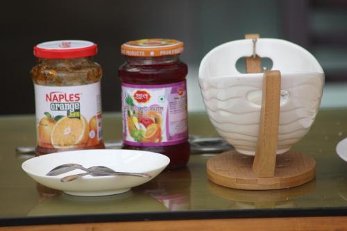 a counter with a bowl and a spoon and a bowl of honey at Anchorage The Residence in Dhaka