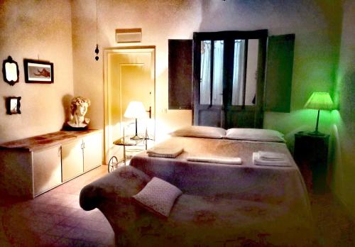 a bedroom with a large bed with a green light at B&B LaMaGia di Corte Moronati in Sirmione