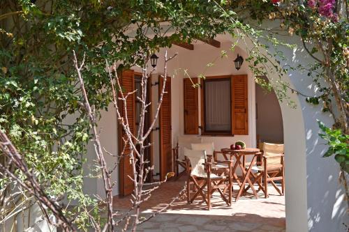 an archway with a table and chairs on a patio at Hippocampus Studios in Antiparos Town