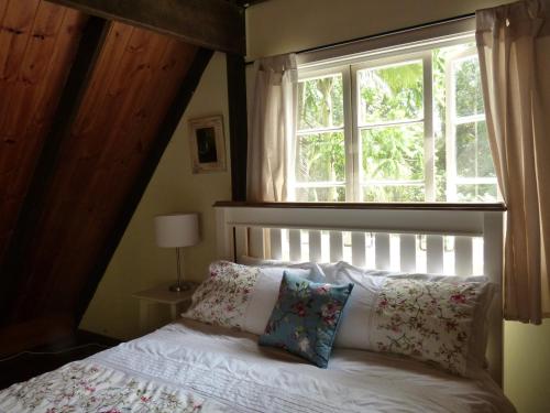 a bedroom with a bed with a window at The Stables in Cooroy