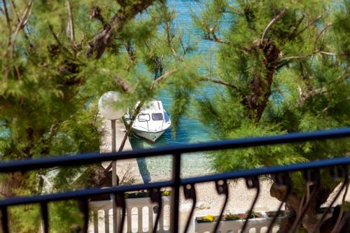 a boat is docked in a body of water at Rooms Marinac in Podstrana