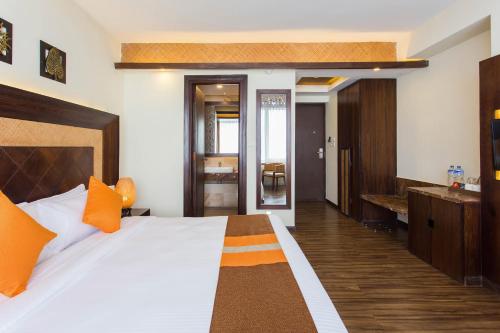a bedroom with a large bed and a bathroom at Hotel Mystic Mountain in Nagarkot