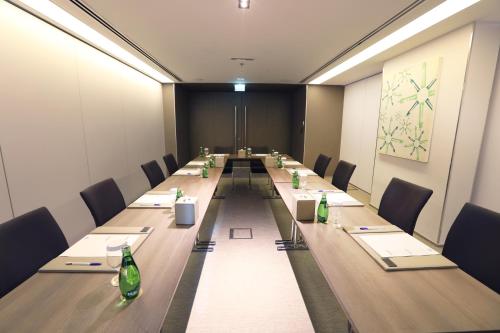 a conference room with a long table and chairs at 72 Hotel Sharjah in Sharjah