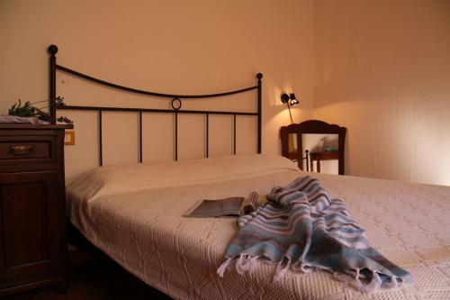 a bedroom with a bed with a blanket on it at SARDINIA RE - Casa Cipro in Castelsardo