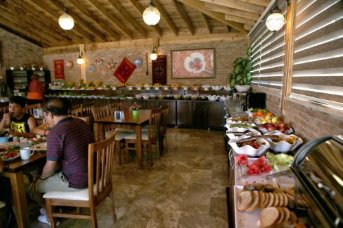 a kitchen filled with lots of tables and chairs at Venus Hotel in Pamukkale