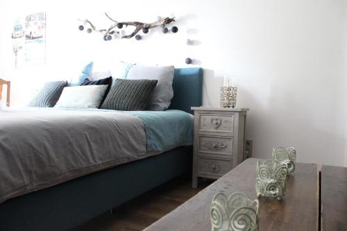 a bedroom with a blue bed and a night stand at (La parenthese) in Hombourg