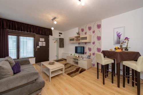 a living room with a couch and a table at Budapest Center Residence in Budapest