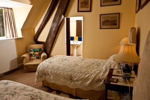 a bedroom with a bed and a table with a lamp at Church Hill Farm in Lighthorne