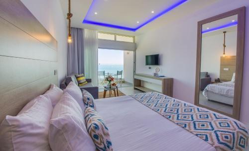 a bedroom with a bed with a view of the ocean at Island Boutique Hotel in Larnaka