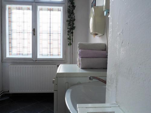 a bathroom with a sink and a bath tub at Hostel El Diablo in Belgrade