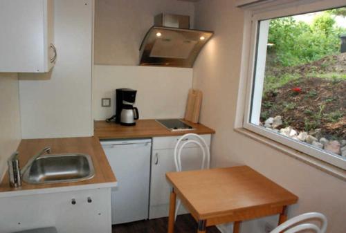 a small kitchen with a sink and a window at Ferienbungalow in Goehren in Göhren