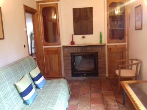a living room with a couch and a fireplace at Casa Julián Fábrica Giner in Morella