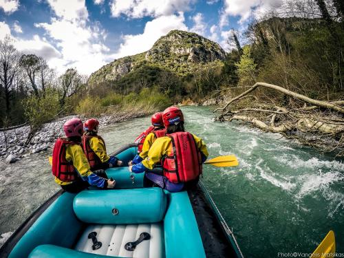 a group of people in a raft on a river at Gaia Guesthouse in Dilofo