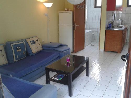 a living room with a blue couch and a coffee table at Holiday Home Free your mind in Dobra Voda