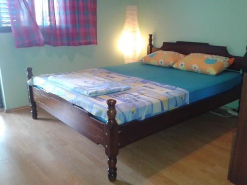 a bed with a blue comforter and pillows on it at Holiday Home Free your mind in Dobra Voda