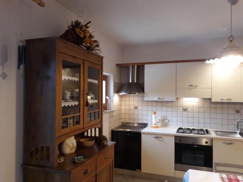 a kitchen with a wooden cabinet and a stove at HartlHof in Proves