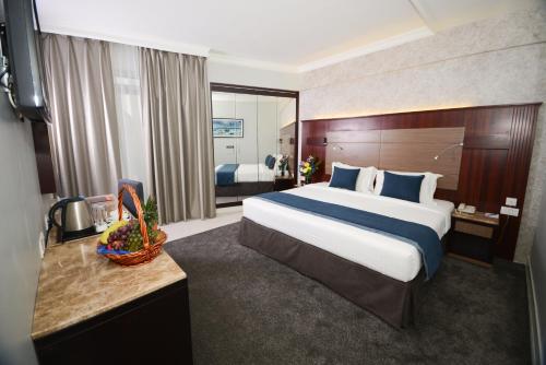 1 dormitorio con 1 cama grande en una habitación de hotel en Fortune Grand Hotel, en Dubái