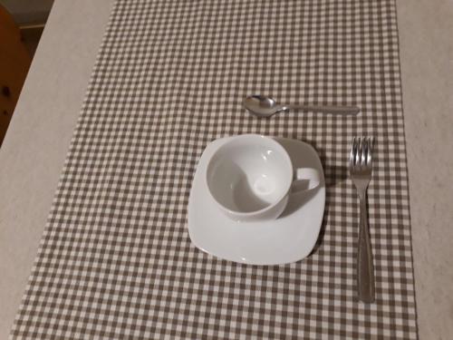 a plate and a spoon and fork on a table at HartlHof in Proves