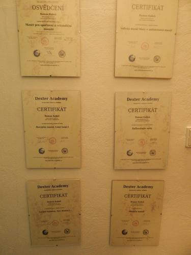 a group of certificates on a wall at Wellness penzion Harmonie Rohanov in Prachatice