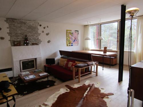 a living room with a couch and a piano at Chalet Vicino a Cortina in Borca di Cadore