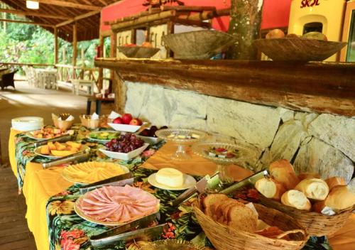 a table with many different types of food on it at Praia da Crena in Abraão