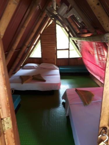 Una cama o camas en una habitación de Hostel Cattleya