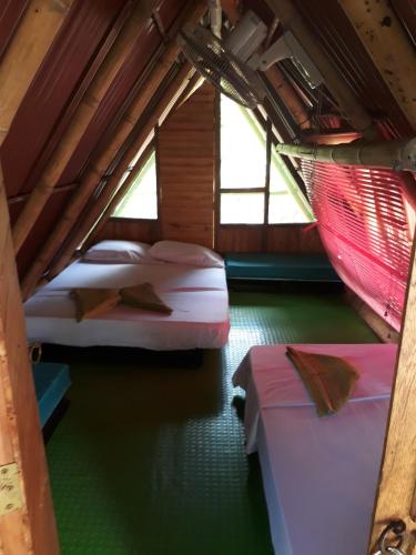 Una cama o camas en una habitación de Hostel Cattleya
