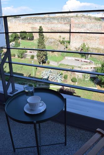 a coffee table with a cup and a glass at Urban Donkey in Thessaloniki