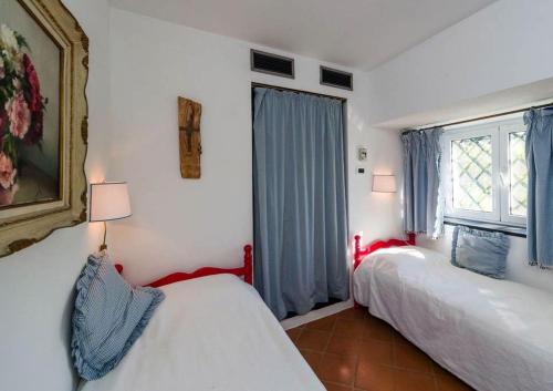 a bedroom with two beds and a window at Cottage san Michele in Rapallo