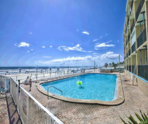 a swimming pool with the beach in the background at Ocean View - Direct Ocean Front-Pool Is Open in Daytona Beach