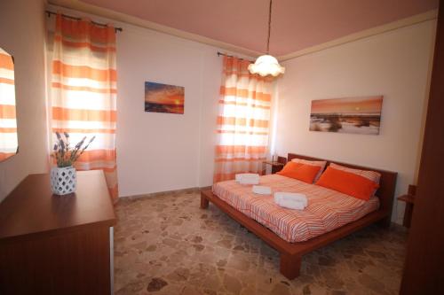 a bedroom with a bed with orange pillows at Dea Beach in Cefalù
