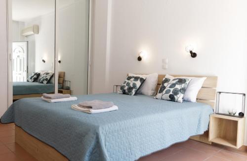 a bedroom with a bed with two towels on it at BLEU- VERT in Prinos