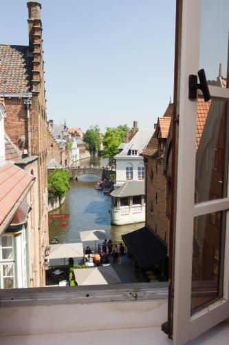 a view of a river from a window at Hotel Bourgoensch Hof in Bruges