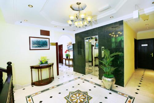 a lobby with a potted plant and a mirror at Muscat International Hotel in Muscat