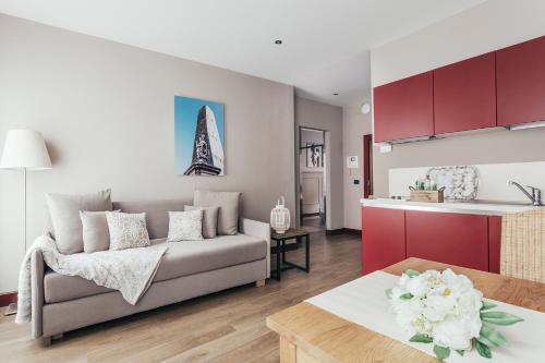 a living room with a couch and a kitchen at Petronio Residence in Bologna