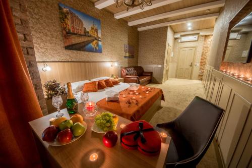 a living room with a table with fruit on it at Hotel Liga in Saint Petersburg