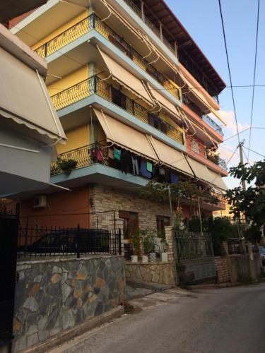 a building with balconies on the side of a street at Apartment Rina in Sarandë