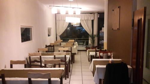 a row of tables and chairs in a restaurant at Hotel Antartida Argentina in Ushuaia