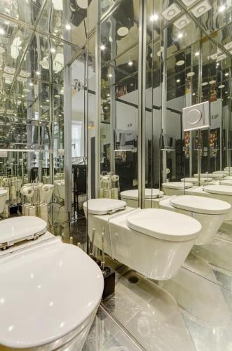 a bathroom with a row of sinks and toilets at Historic Centre Apartments VI in Prague