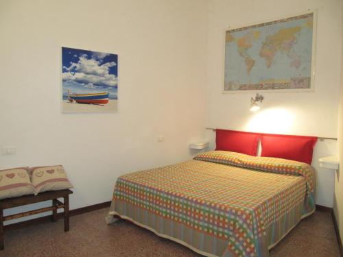 a bedroom with a bed and a map on the wall at La Casa dell ' Orto in Lerici