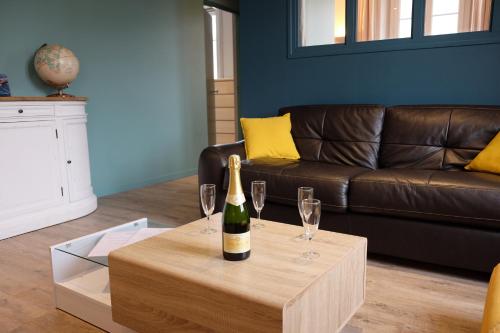 - une bouteille de vin sur une table avec deux verres dans l'établissement Appartement Saint Malo-Rocabey, à Saint-Malo