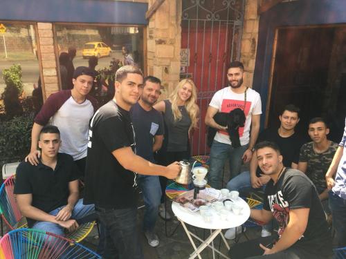 a group of people posing for a picture with a table at Yolo Hostel Medellin in Medellín