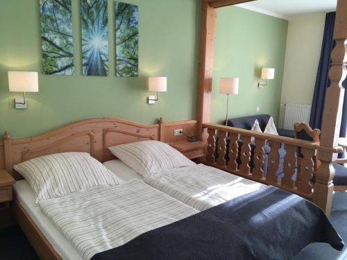 a bedroom with a large bed with two pillows at Flair Landhotel Strengliner Mühle in Pronstorf