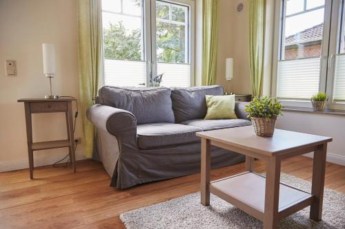 a living room with a couch and a table at Flair Landhotel Strengliner Mühle in Pronstorf