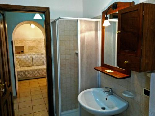 een badkamer met een wastafel en een douche bij I Trulli degli Ulivi in Locorotondo